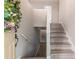 Bright, modern stairwell with light gray floors and white railings at 4171 Whispering Forest Sw Ct, Lilburn, GA 30047
