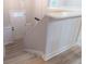 Stairwell featuring new floors, white wainscotting, and door to lower level at 4171 Whispering Forest Sw Ct, Lilburn, GA 30047