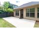 Spacious back patio with door access to the home and grass yard at 4584 Brook Farms Dr, Duluth, GA 30096