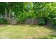 Landscaped backyard features a well-maintained lawn and wooden fence at 4584 Brook Farms Dr, Duluth, GA 30096