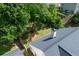 This aerial view showcases a backyard featuring a well-maintained lawn and mature trees for added privacy at 4584 Brook Farms Dr, Duluth, GA 30096