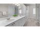 Bright bathroom with double sinks, white cabinets, and a glass enclosed shower at 4584 Brook Farms Dr, Duluth, GA 30096