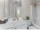 Bright bathroom features a white vanity, toilet, and shower-tub combination at 4584 Brook Farms Dr, Duluth, GA 30096
