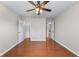 Bedroom with ceiling fan, wood floors, and access to bathroom and walk-in closet at 4584 Brook Farms Dr, Duluth, GA 30096