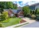 Charming single-story home with brick exterior and a well-manicured front yard at 4584 Brook Farms Dr, Duluth, GA 30096