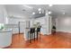Bright kitchen with white cabinets, hardwood floors, an island, and granite countertops at 4584 Brook Farms Dr, Duluth, GA 30096