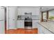 Renovated kitchen with subway tile backsplash, white cabinetry, and stainless-steel appliances at 4584 Brook Farms Dr, Duluth, GA 30096