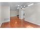 Open-concept living area with hardwood floors, fireplace, and modern lighting fixtures at 4584 Brook Farms Dr, Duluth, GA 30096