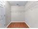 Walk-in closet with ample shelving and hardwood floors at 4584 Brook Farms Dr, Duluth, GA 30096