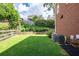 Lush green backyard with meticulously maintained lawn, garden area and fenced perimeter at 5370 Newport Bay Psge, Alpharetta, GA 30005