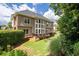 Beautiful backyard featuring a wooden deck, lush landscaping, and a well-maintained lawn at 5370 Newport Bay Psge, Alpharetta, GA 30005