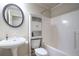 Cozy bathroom featuring a pedestal sink, built-in cabinet, and a tub with shower at 5370 Newport Bay Psge, Alpharetta, GA 30005