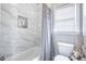 This pristine bathroom has white marble tiles, a niche, and a window, perfect for relaxation at 5370 Newport Bay Psge, Alpharetta, GA 30005
