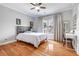 Comfortable bedroom featuring a ceiling fan, natural light, and a desk area for study or work at 5370 Newport Bay Psge, Alpharetta, GA 30005