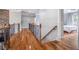 Spacious hallway with hardwood floors and decorative railing leading to bedrooms at 5370 Newport Bay Psge, Alpharetta, GA 30005