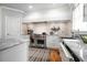 Well-lit kitchen features stainless steel appliances, white cabinets, and stone countertops at 5370 Newport Bay Psge, Alpharetta, GA 30005
