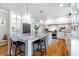 Kitchen with white cabinetry, stone countertops, stainless appliances, and an island with seating at 5370 Newport Bay Psge, Alpharetta, GA 30005