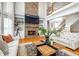Open-concept living room with stone fireplace, built-in shelves, and soaring ceilings at 5370 Newport Bay Psge, Alpharetta, GA 30005