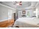 Spacious main bedroom with tray ceiling, hardwood floors, and ensuite bath at 5370 Newport Bay Psge, Alpharetta, GA 30005