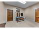 Bonus room offering versatility for a home gym, playroom, or hobby space with neutral walls and carpet at 5945 W Andechs Smt, Johns Creek, GA 30097