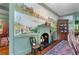 Dining room fireplace with a hand-painted river mural above at 5945 W Andechs Smt, Johns Creek, GA 30097