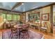Charming dining area with wood table, chairs, hutch, and scenic backyard views at 5945 W Andechs Smt, Johns Creek, GA 30097