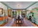 Elegant dining room with hand-painted mural, fireplace, long table, and natural light at 5945 W Andechs Smt, Johns Creek, GA 30097