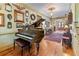 Elegant foyer with hardwood floors, piano, gallery wall, and period lighting at 5945 W Andechs Smt, Johns Creek, GA 30097