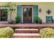 Inviting front porch with classic decor, manicured landscaping, and a brick-lined entrance at 5945 W Andechs Smt, Johns Creek, GA 30097