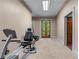 Home gym featuring exercise equipment and hardwood double doors allowing for an at-home fitness routine at 5945 W Andechs Smt, Johns Creek, GA 30097