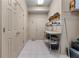 Functional laundry room with tile floors, built-in storage, and ample space for sorting and folding at 5945 W Andechs Smt, Johns Creek, GA 30097