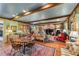 Spacious living and dining area with wood floors, exposed beams, and a fireplace at 5945 W Andechs Smt, Johns Creek, GA 30097