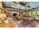 Open-concept floor plan featuring a living and dining room with exposed wood beams at 5945 W Andechs Smt, Johns Creek, GA 30097