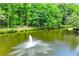 Picturesque pond with a fountain surrounded by lush trees at 5945 W Andechs Smt, Johns Creek, GA 30097