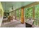 Spacious porch with a dining table set for entertaining overlooking lush greenery at 5945 W Andechs Smt, Johns Creek, GA 30097