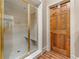 Elegant shower with glass doors, bench, and gold fixtures showcasing luxurious bathroom finishes at 5945 W Andechs Smt, Johns Creek, GA 30097