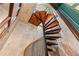 Unique spiral staircase featuring wooden treads and black wrought iron railing at 5945 W Andechs Smt, Johns Creek, GA 30097