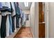 Spacious walk-in closet with ample hanging space and built-in storage options for organized clothing and accessories at 5945 W Andechs Smt, Johns Creek, GA 30097