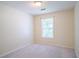 Cozy bedroom featuring neutral walls, plush carpet, and a bright window at 6366 Jasper Ct, Tucker, GA 30084