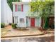 Charming townhome with light blue siding, red shutters, and a well-maintained front yard for sale at 6366 Jasper Ct, Tucker, GA 30084
