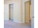 Hallway featuring neutral walls and carpet flooring, with open doors to other rooms at 6366 Jasper Ct, Tucker, GA 30084