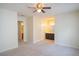 A large main bedroom with neutral carpet, a ceiling fan and bathroom with double sinks at 6366 Jasper Ct, Tucker, GA 30084