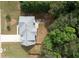 Aerial view of house with large backyard, patio and surrounded by mature trees at 1583 Rogers Crossing Dr, Lithonia, GA 30058