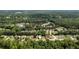 Overhead perspective of the property within a scenic neighborhood near a serene pond and abundant greenery, offering tranquility at 1583 Rogers Crossing Dr, Lithonia, GA 30058