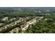 High-angle drone image of the property, displaying its placement in a verdant neighborhood amidst mature trees and landscaping at 1583 Rogers Crossing Dr, Lithonia, GA 30058