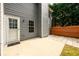Exterior view of a back patio, house siding and fencing for added backyard privacy at 1583 Rogers Crossing Dr, Lithonia, GA 30058