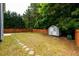 View of backyard featuring a shed, a wood fence, and a small iron pergola at 1583 Rogers Crossing Dr, Lithonia, GA 30058
