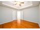 Bright bedroom with hardwood floors and a tray ceiling at 1583 Rogers Crossing Dr, Lithonia, GA 30058