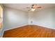 Bright, vacant bedroom featuring a ceiling fan and hardwood floors at 1583 Rogers Crossing Dr, Lithonia, GA 30058
