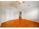 Spacious bedroom with hardwood floors and large closet doors at 1583 Rogers Crossing Dr, Lithonia, GA 30058